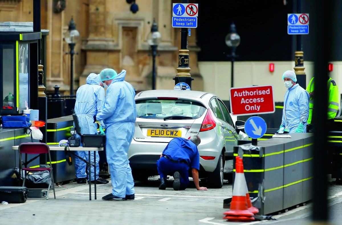 Forensic investigators work at the site after a car crashed outside the Houses of Parliament in Westminster, London, Britain, August 14, 2018. Reuters/Henry Nicholls