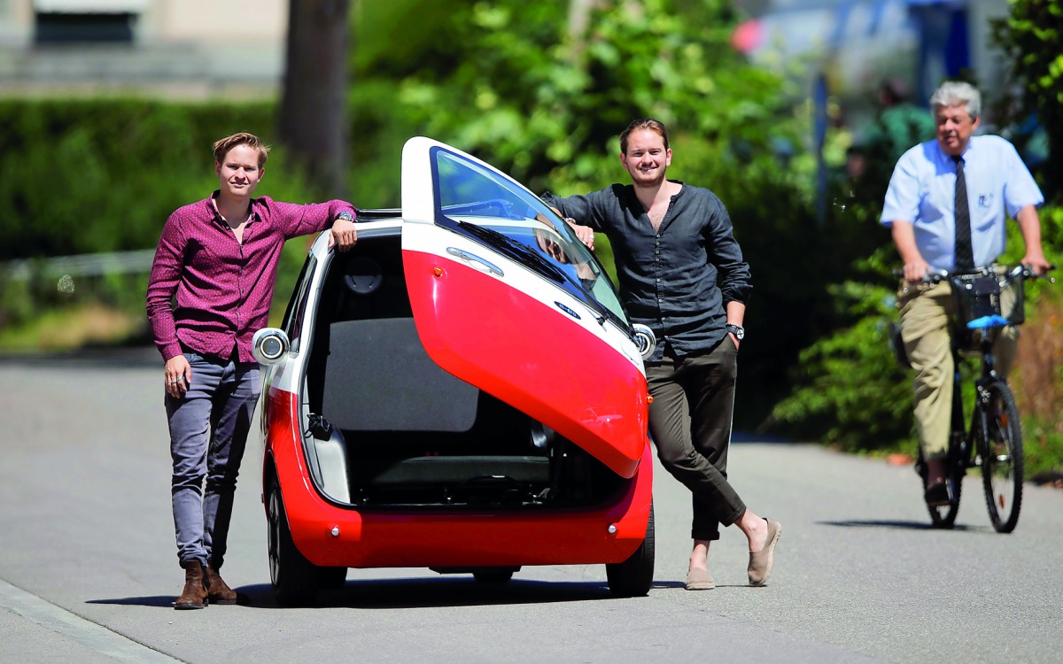 Chief Operating Officer Oliver (L) and his brother Chief Marketing Officer Merlin Ouboter of Swiss Microlino AG pose beside an electric-powered Microlino car in Kuesnacht, Switzerland July 13, 2018. Picture taken July 13, 2018. Reuters/Arnd Wiegmann