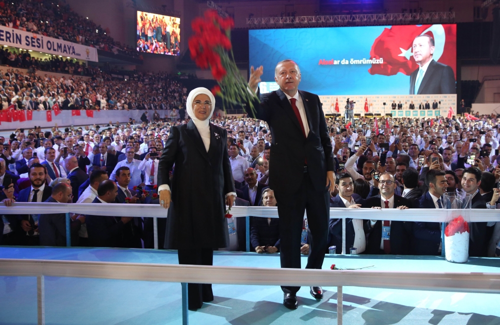 Turkish President Tayyip Erdogan (R) and his wife Emine Erdogan (L), greet supporters ruling Justice and Development Party (AKP) during the sixth congress of the ruling AK party (AKP) to prepare for March local election in Ankara on August 18, 2018. (AFP 