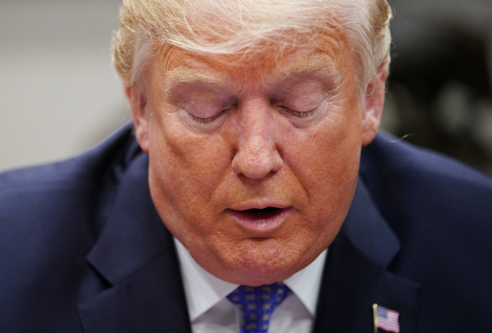 US President Donald Trump speaks during a roundtable discussion on the Foreign Investment Risk Review Modernization Act in the Roosevelt Room of the White House on August 23, 2018. / AFP / MANDEL NGAN