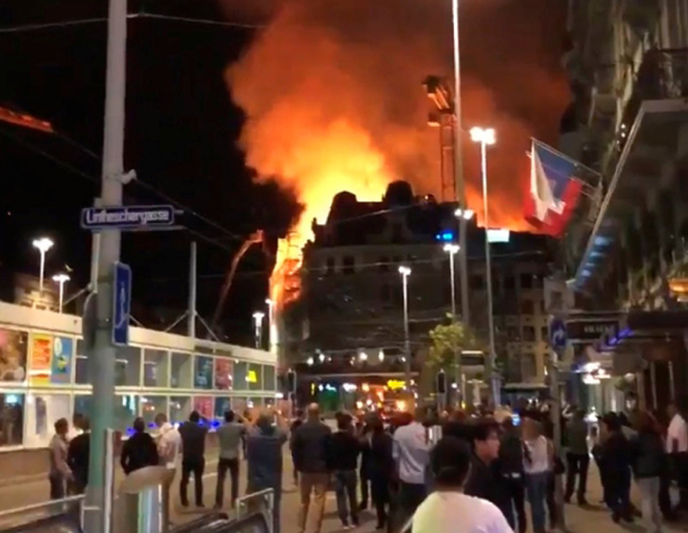 A fire is seen near Bahnhofplatz in Zurich, Switzerland, August 25, 2018 in this still image taken from a social media video. 