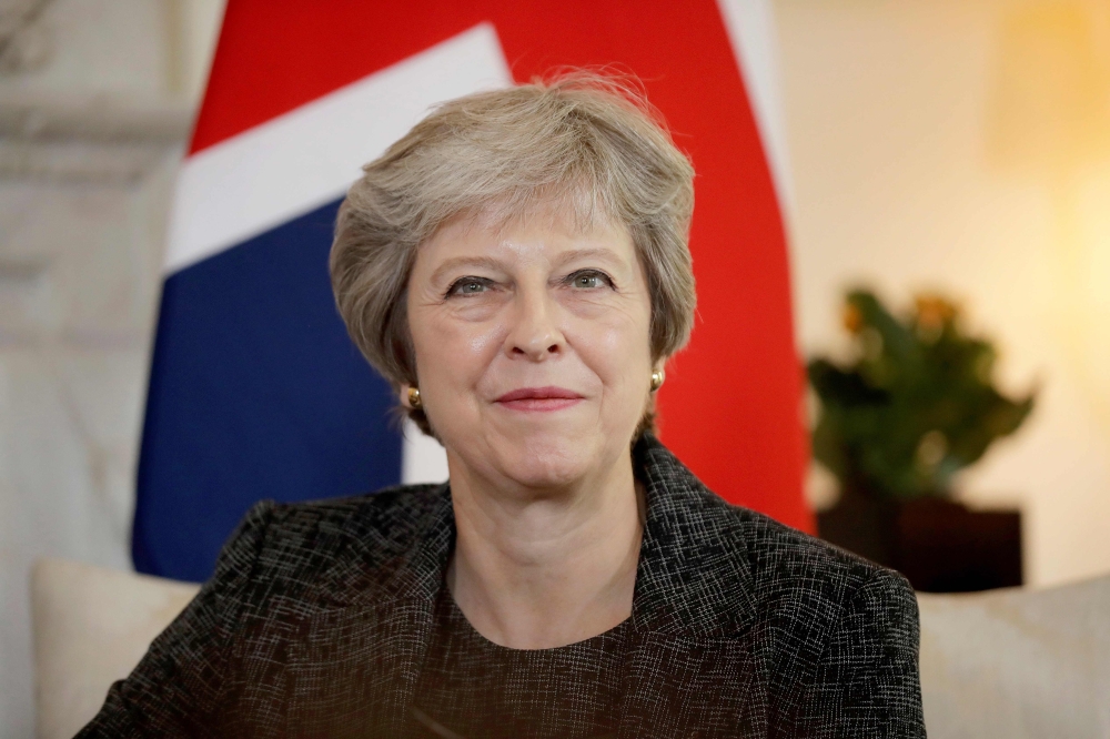 File photo of Prime Minister Theresa May will make a three-nation visit to Africa this week, her first to the continent since becoming British leader in 2016, aimed at boosting post-Brexit trade ties, July 24, 2018. / AFP / POOL / Matt Dunham 