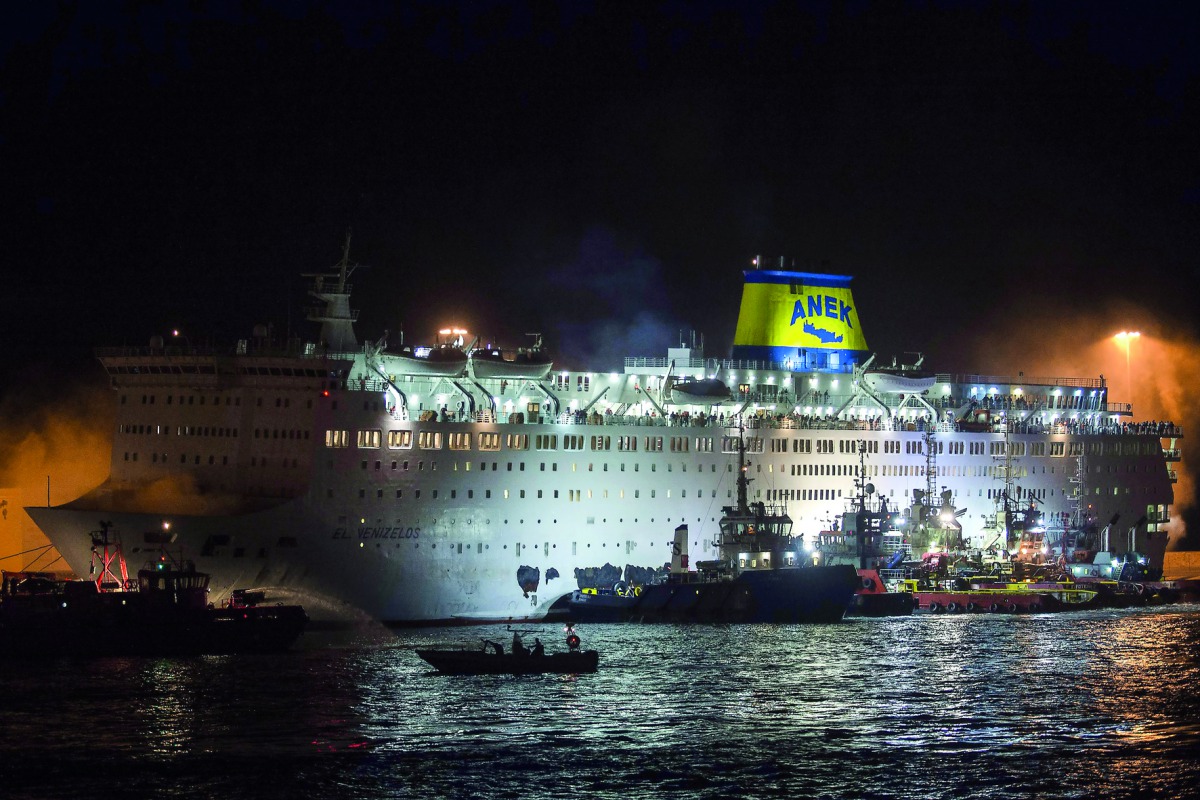 A firefighting vessel tries to extinguish a fire on the ferry Eleftherios Venizelos, at the port of Piraeus early in the morning, in Athens, on August 29, 2018.  AFP / Angelos Tzortzinis 

 
