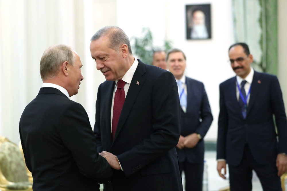 Russia's President Vladimir Putin (L) shaking hands with his Turkey's counterpart Recep Tayyip Erdogan during their meeting in Tehran on September 7, 2018. -  AFP PHOTO /Turkish Presidential Press Office 