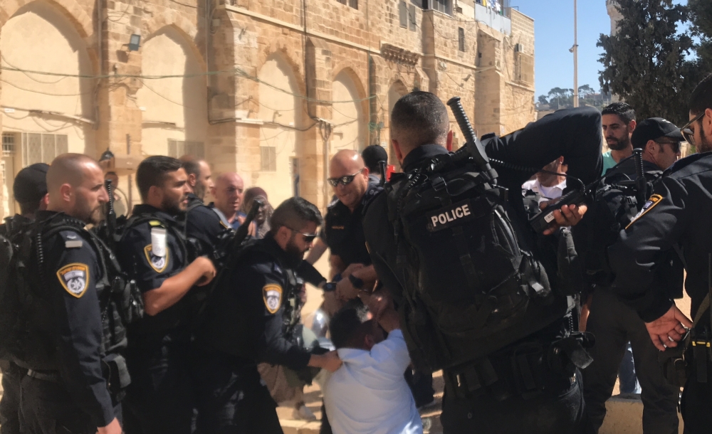 Israeli security forces take a Palestinian into custody as Israeli settlers storm Al-Aqsa compound in East Jerusalem on September 18, 2018. (Jerusalem Islamic Waqf/Anadolu Agency)