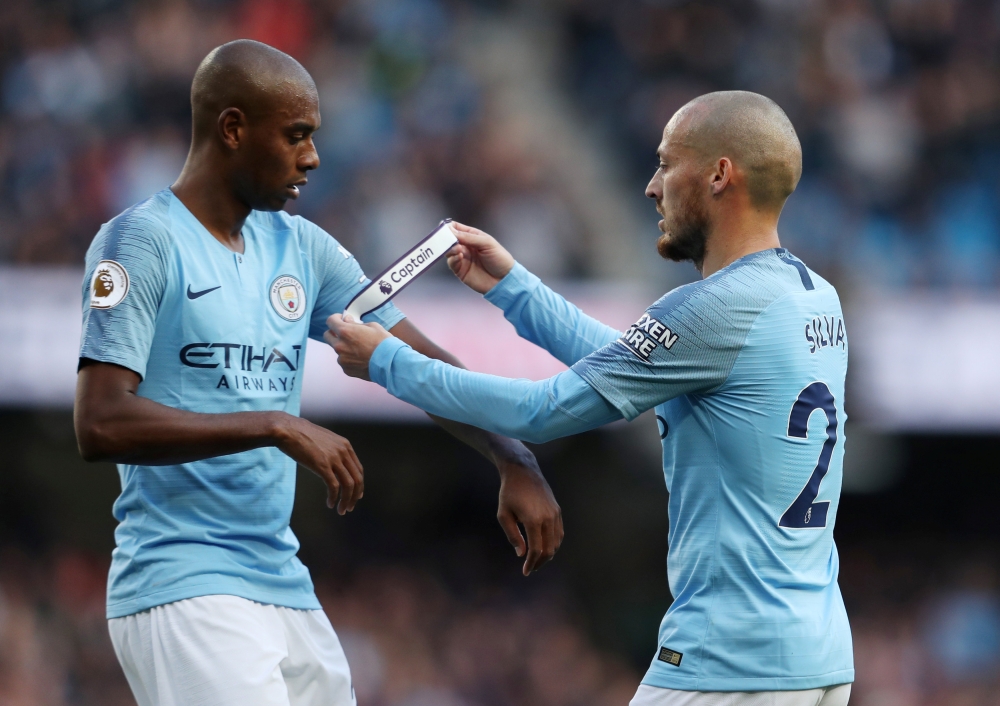 Manchester City's David Silva gives the captain's armband to teammate Fernandinho as he is substituted off Action Images via Reuters/Lee Smith 