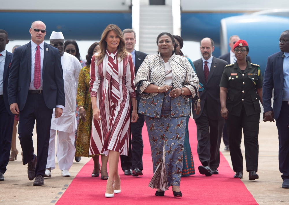 US First Lady Melania Trump walks alongside Rebecca Akufo-Addo, the First Lady of Ghana, during an arrival ceremony after landing at Kotoka International Airport in Accra October 2, 2018 as she begins her week long trip to Africa to promote her 'Be Best' 