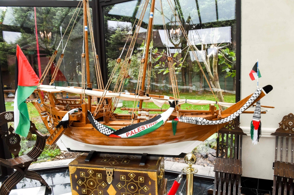 This picture taken on October 2, 2018 shows a modelled boat with palestinian flags on it displayed in room of the Zahra Centre, the headquarters of a a Shiite Islamic association in Grande Synthe, northern France, after it was raided by 200 police men as 