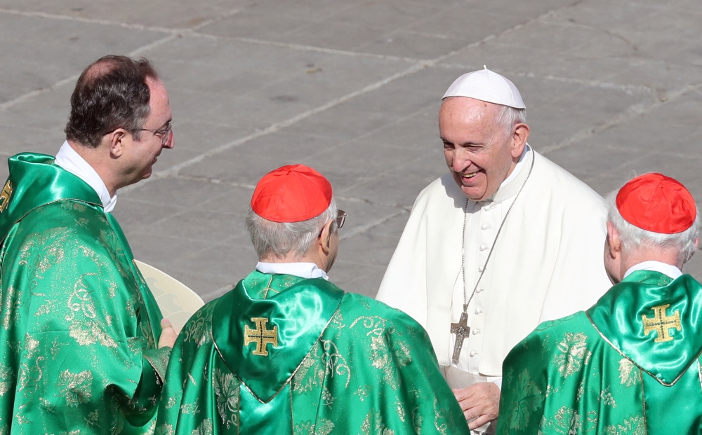 Pope Francis greets cardinals at the end of a mass for the opening of a synodal meeting in Saint Peter's square, at the Vatican, October 3, 2018. REUTERS/Tony Gentile 