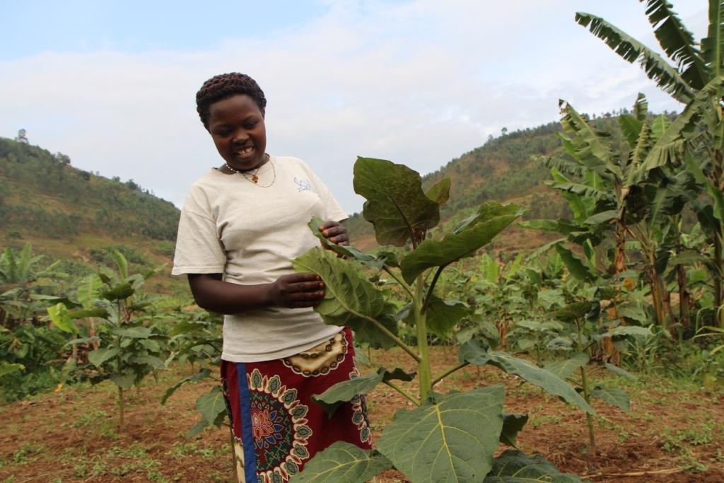 Marie Chantal Akingeneye, 28, a single mother, poses in her vegetable plot in Rulindo district in northern Rwanda on Aug 22, 2018. Thomson Reuters Foundation/Thin Lei Win
