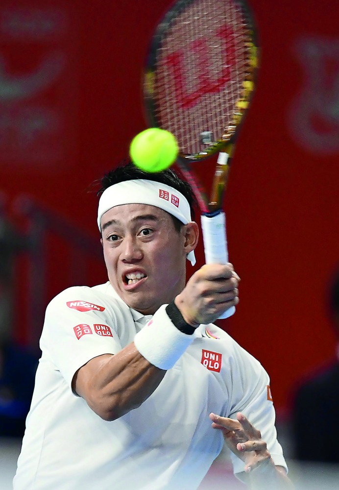 Japan's Kei Nishikori hits a return against Greece's Stefanos Tsitsipas during the men's singles quarter-finals at the Japan Open tennis championships in Tokyo on October 5, 2018. AFP / Kazuhiro Nogi

