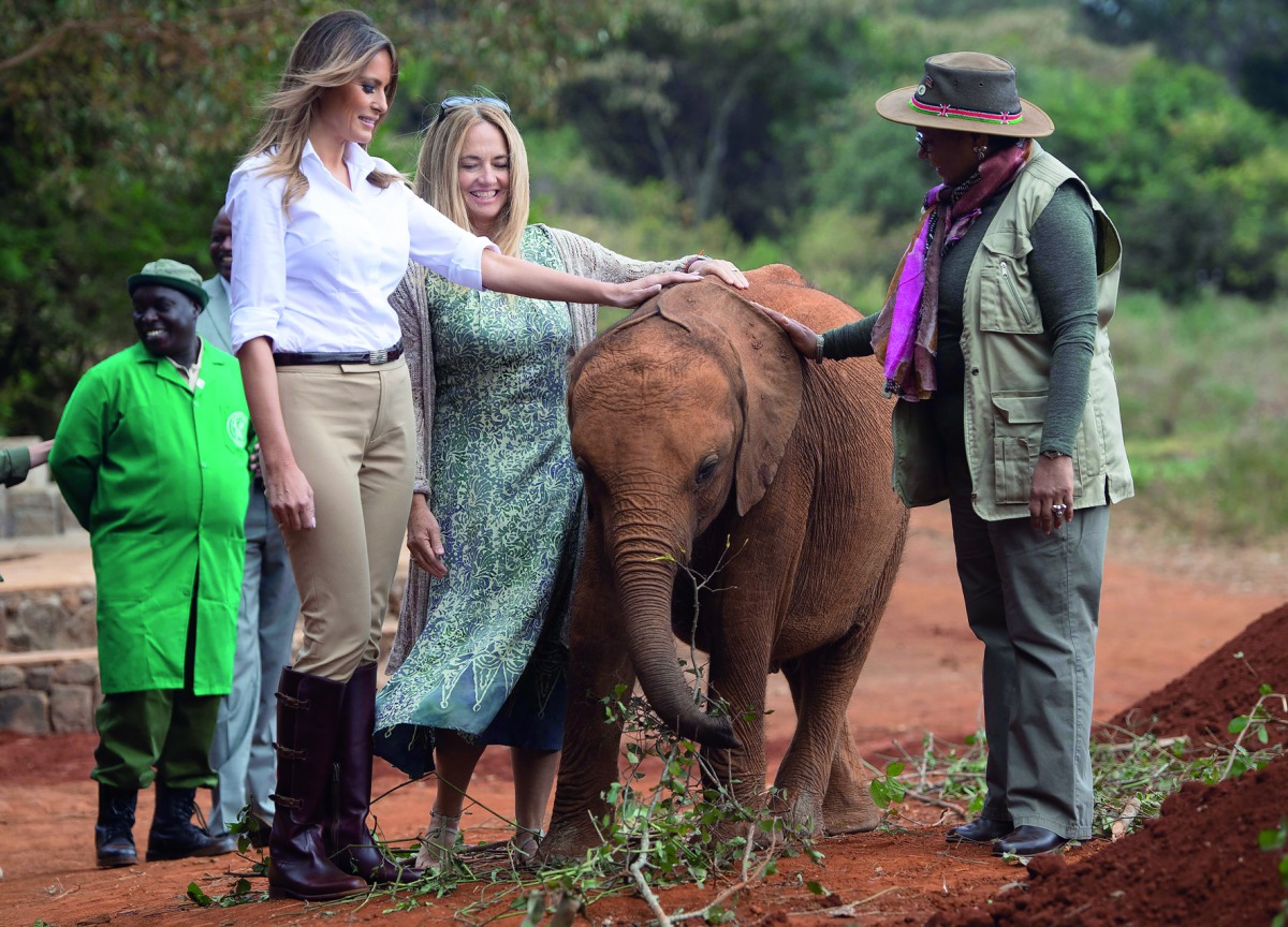 US First Lady Melania Trump (L) and First Lady of Kenya Margaret Kenyatta (R) pet a baby elephant at The David Sheldrick Elephant Orphanage in Nairobi on October 5, 2018, as she pays a one day visit to the country during her solo tour of Africa promoting 