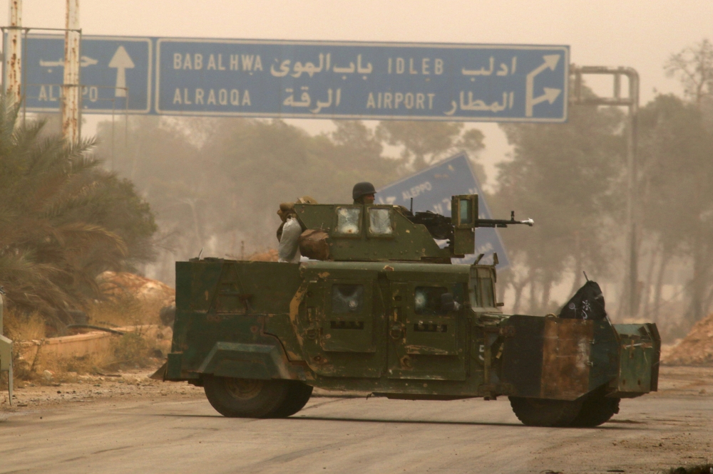 FILE PHOTO : A rebel fighter rides a military vehicle in Dahiyat al-Assad, west Aleppo city, Syria October 28, 2016. REUTERS/Ammar Abdullah
