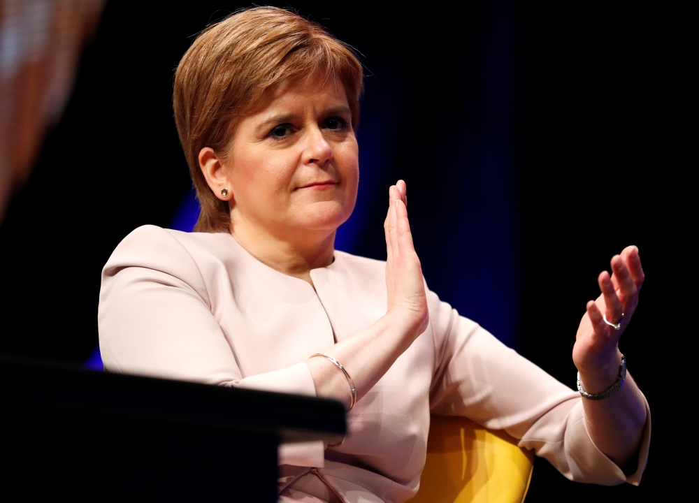 Scotland's First Minister Nicola Sturgeon listens to Plaid Cymru's leader Adam Price speak at the Scottish National Party's party's conference in Glasgow, Scotland, Britain, October 8, 2018. REUTERS/Russell Cheyne