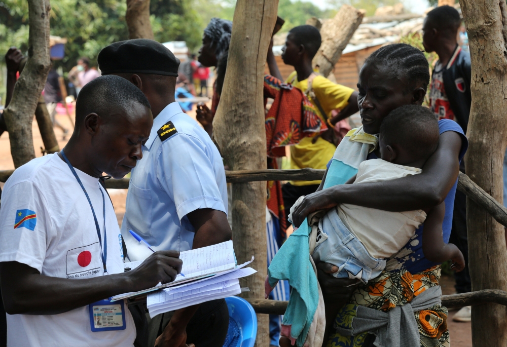 An official from the International Organization for Migration (IOM) collects data and registers a Congolese migrant who crossed from Angola at the Kamako border, Kasai province in the Democratic Republic of the Congo, October 13, 2018. Picture taken Octob