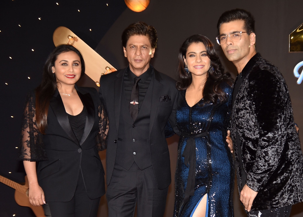 Indian Bollywood actors Rani Mukharjee (L), Shah Rukh Khan (2L) and Kajol Devgan (2R) and Director Karan Johar pose for a picture as they attend an event celebrating the 20th anniversary of the Hindi film 