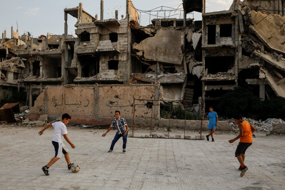 Children play football in al-Khalidiya area, in the government-controlled part of Homs, Syria, September 18, 2018.   REUTERS/Marko Djurica