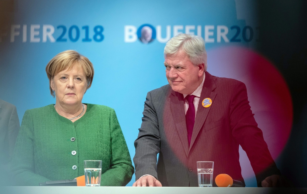 German Chancellor Angela Merkel (L) and Hesse's State Premier and Deputy Chairman of the Christian Democratic Union (CDU) Volker Bouffier address an election rally in Fulda, western Germany on October 25, 2018 ahead of the weekend's regional election. Ger