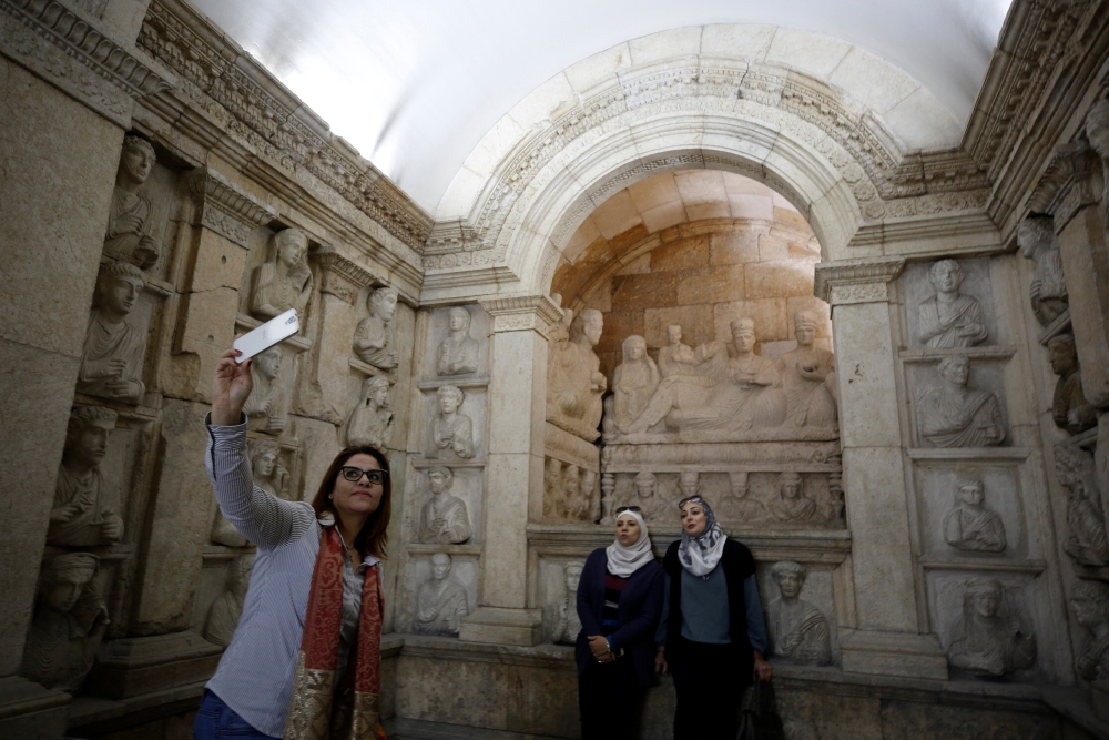 A visitor uses her mobile phone to take a selfie during the reopening of Syria's National Museum of Damascus, Syria October 28, 2018. REUTERS/Omar Sanadiki