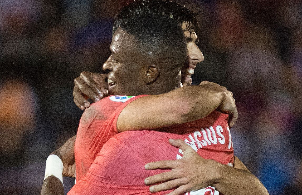 Real Madrid's Spanish midfielder Marco Asensio (L) celebrates with Real Madrid's Brazilian forward Vinicius Junior after scoring a goal during the Spanish King's Cup (Copa del Rey) football match between UD Melilla and Real Madrid CF at the Alvarez Claro 
