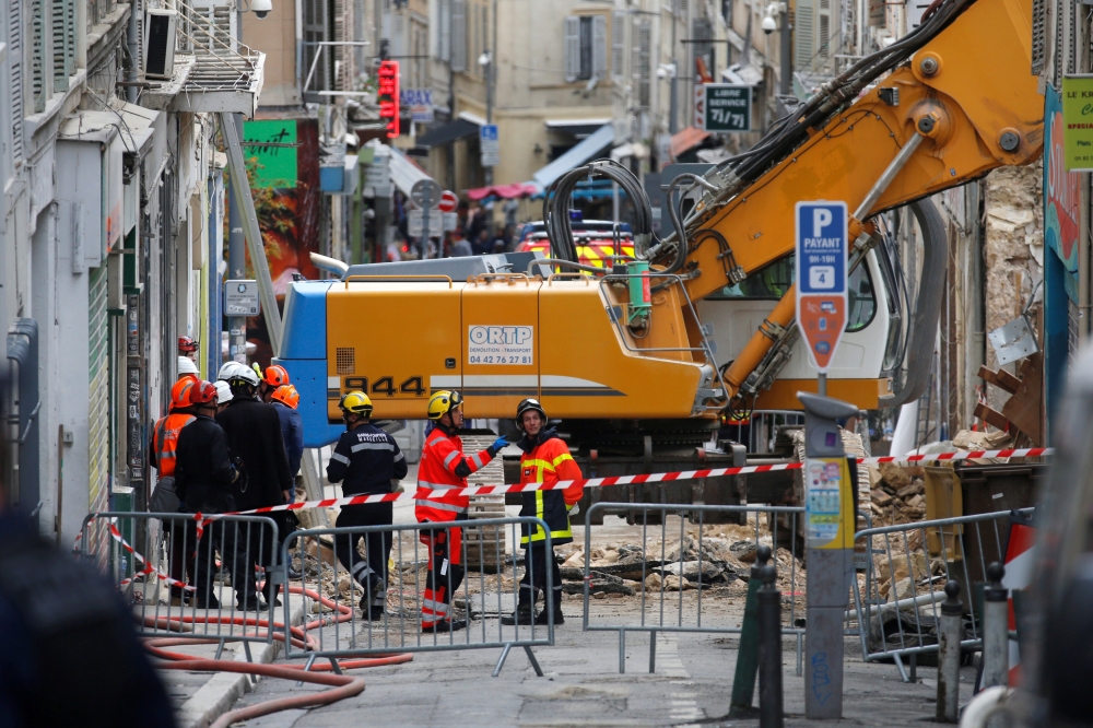 French rescue workers and emergency services work near the rubble of two dilapidated buildings that collapsed this week in the city of Marseille, France, November 7, 2018. REUTERS/Jean-Paul Pelissier 