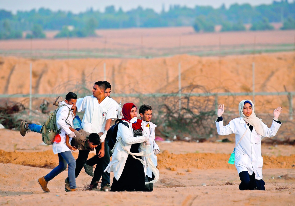 A wounded protester is evacuated during a demonstration near the border between Israel and Khan Yunis in the southern Gaza Strip on November 9, 2018. AFP / Said Khatib
