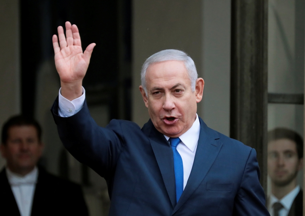 Israeli Prime Minister Benjamin Netanyahu waves as he arrives at the Elysee Palace after the commemoration ceremony for Armistice Day, 100 years after the end of World War One, in Paris, France, November 11, 2018. Reuters/Reinhard Krause