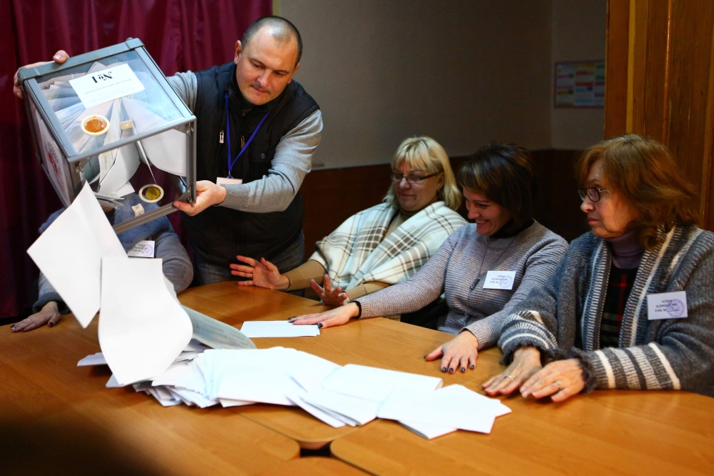 The election commission members count ballots at polling station in Donetsk, in the rebel-held area of eastern Ukraine on November 11, 2018, as Kremlin-backed separatists choose their new leaders despite Western calls on Moscow not to sabotage peace talks