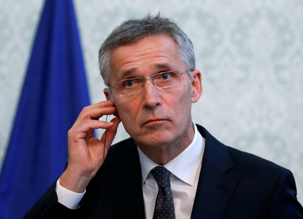 NATO Secretary General Jens Stoltenberg adjusts his earphone during a joint news conference with Afghanistan's President Ashraf Ghani (unseen) in Kabul, Afghanistan November 6, 2018. REUTERS/Mohammad Ismail
