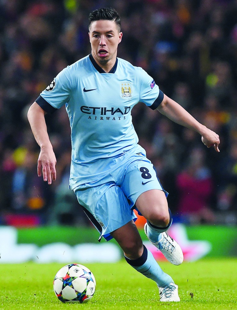 In this file photo taken on February 24, 2015 Manchester City's French midfielder Samir Nasri runs with the ball during the UEFA Champions League round of 16 first leg football match between Manchester City and Barcelona at the Etihad Stadium in Mancheste