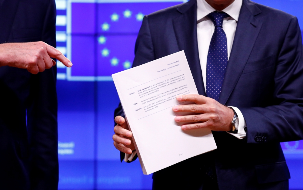European Council President Donald Tusk poses with the Brexit draft text handed over by European Union's chief Brexit negotiator Michel Barnier in Brussels, Belgium, November 15, 2018. REUTERS/Francois Lenoir