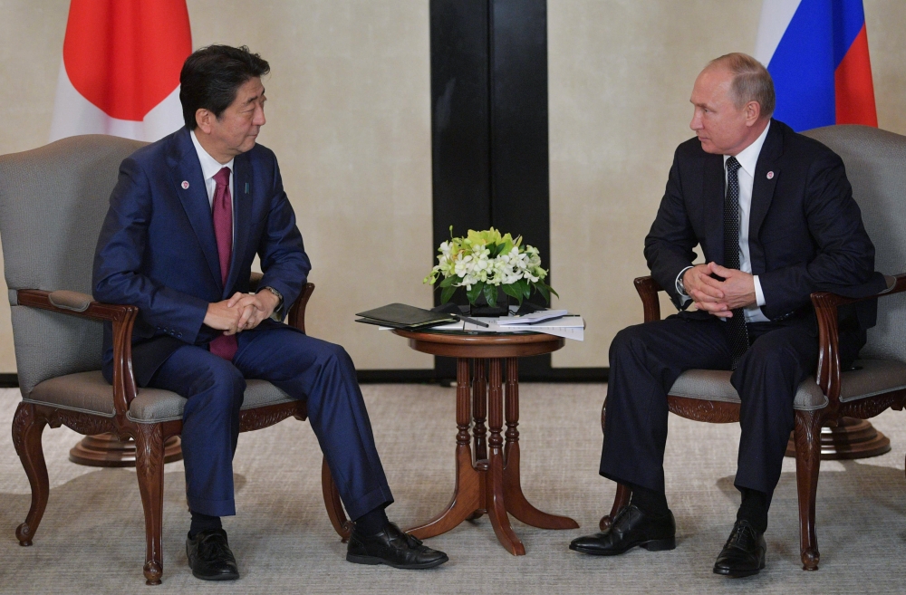 Japanese Prime Minister Shinzo Abe and Russian President Vladimir Putin attend a meeting on the sidelines of the ASEAN-Russia Summit in Singapore, November 14, 2018. Sputnik/Alexei Druzhinin/Kremlin via 