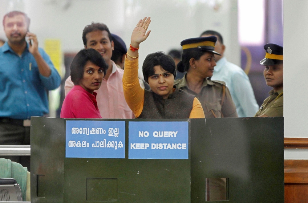 Trupti Desai, a women's rights activist, waves from inside the Cochin International Airport at Kochi, India, November 16, 2018. Reuters /Sivaram V