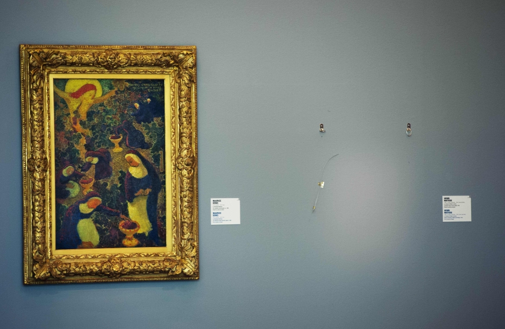 FILE PHOTO: In this file photo taken on October 16, 2012, an empty space is seen where a painting by French artist Henri Matisse was stolen at the Kunsthal museum in Rotterdam, a day after seven masterpieces were stolen in a pre-dawn heist.  AFP/ ROBIN UT
