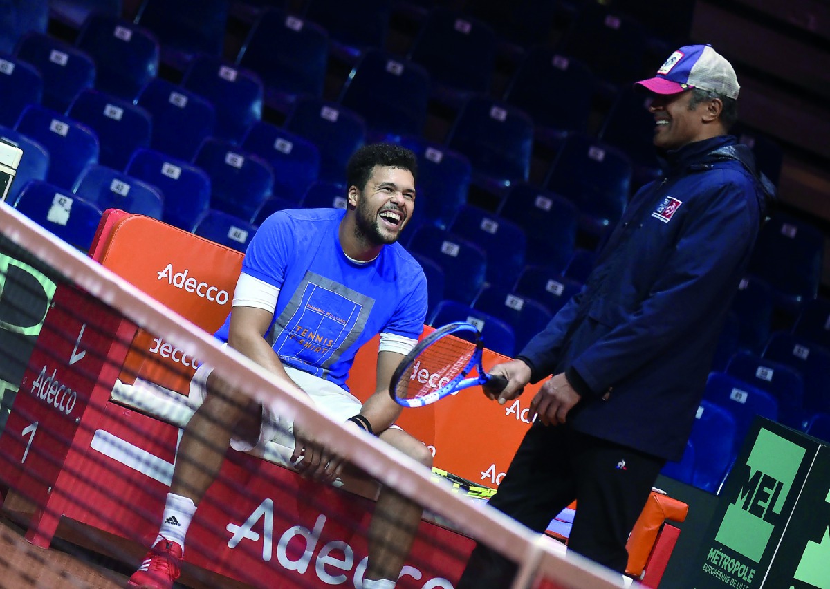 France's Jo-Wilfried Tsonga (L) shares a light moment with team captain Yannick Noah during a training session at The Pierre Mauroy Stadium in Villeneuve d'Ascq on November 21, 2018, ahead of the Davis Cup final tennis match that is scheduled to take plac