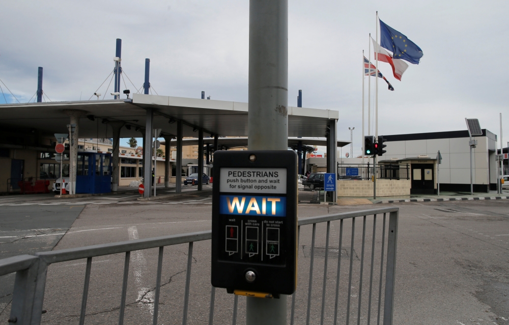 The European Union flag, Gibraltarian flag and Britain's Union Jack flies along at the border in the British overseas territory of Gibraltar, historically claimed by Spain, November 23, 2018. Reuters/Jon Nazca