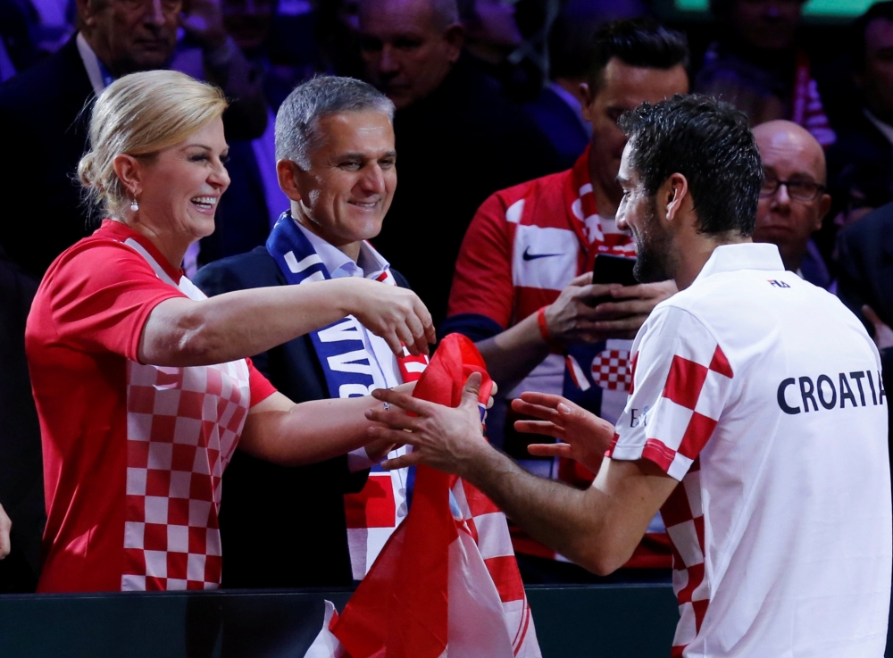 Croatia President Kolinda Grabar-Kitarovic congratulates Marin Cilic after Croatia win the Davis Cup REUTERS/Pascal Rossignol
