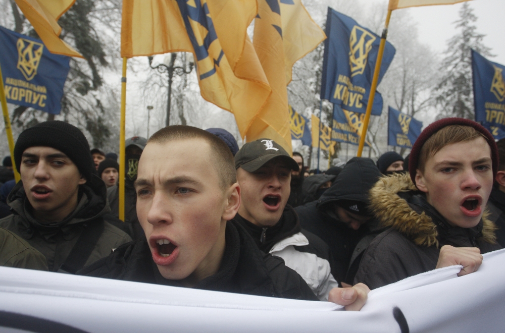 Ukrainian far-right groups attend a rally demanding to set martial law in the country and to cut diplomatic relations with Russia, after Russian navy seized three Ukrainian ships off near the Crimea, in front of the Ukrainian Parliament in Kiev, Ukraine, 