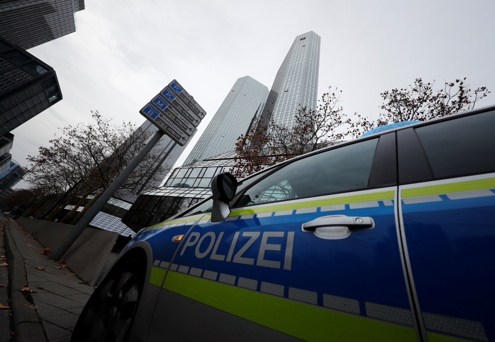 :Police vehicles are parked in front of Deutsche Bank headquarters as roughly 170 criminal police officers, prosecutors and tax inspectors searched Deutsche Bank offices in and around Frankfurt, Germany, November 29, 2018, on money laundering allegations,