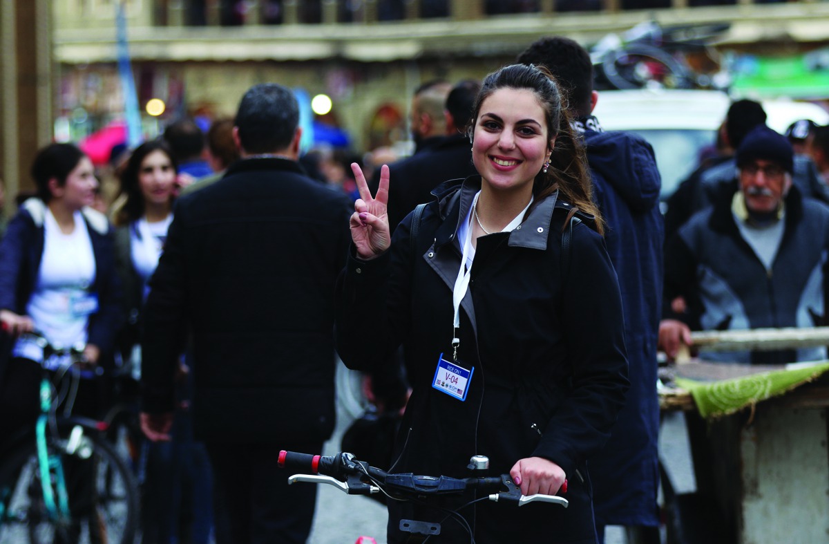 A participant gestures as she competes during the Arbil international bike marathon, in the northern Iraqi city of Arbil, the capital of the autonomous Kurdish region, on November 30, 2018. AFP / Safin Hamed