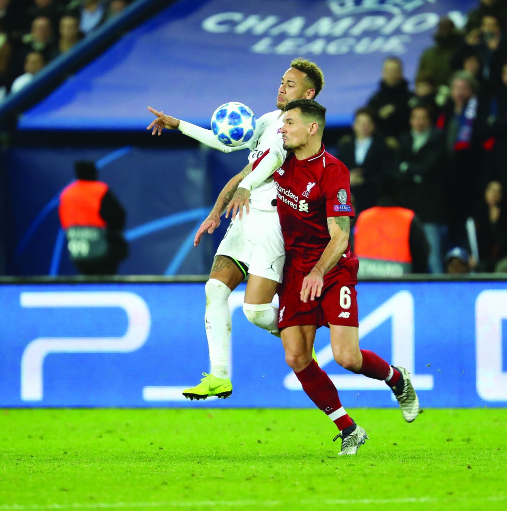 Neymar (L) of Paris Saint-Germain (PSG) in action against Dejan Lovren (R) of Liverpool during the UEFA Champions League Group C soccer match between Paris Saint Germain and Liverpool at Parc des Princes Stadium in Paris, France on November 28, 2018 (Must