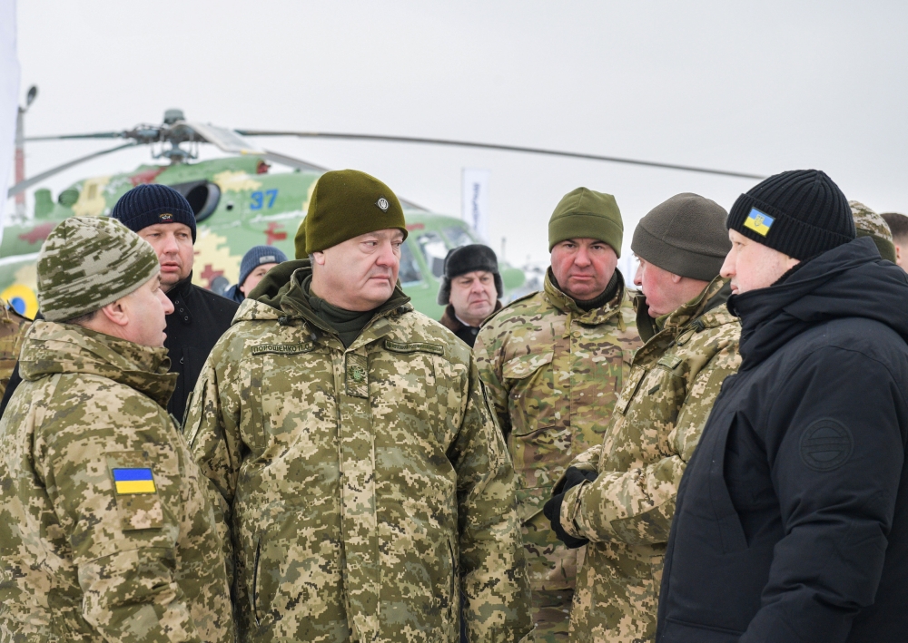 Ukraine's President Petro Poroshenko (2nd L), Defence Minister Stepan Poltorak (L) and Secretary of the National Security and Defence Council Oleksander Turchinov visit an airbase of the 40th Tactical Aviation Brigade of the Ukrainian Armed Forces in Vasy