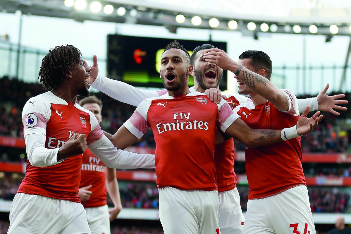 Arsenal's Gabonese striker Pierre-Emerick Aubameyang (C) celebrates after scoring the opening goal from the penalty spot during the English Premier League football match between Arsenal and Tottenham Hotspur at the Emirates Stadium in London on December 2