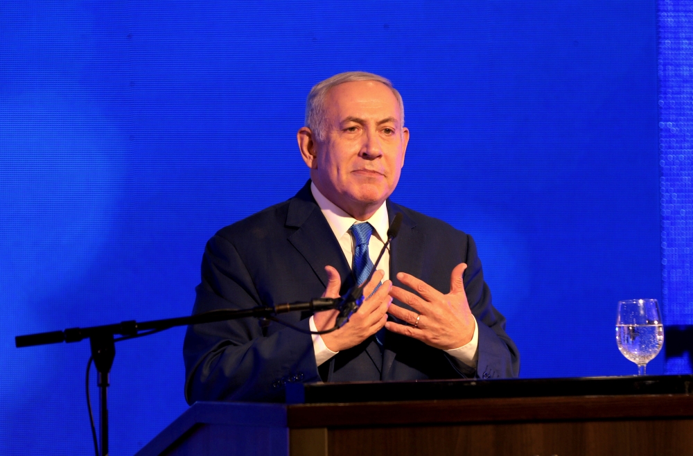 Israeli Prime Minister Benjamin Netanyahu speaks during an Likud Party gathering marking the first day of the eight-day Jewish holiday of Hanukkah, in Ramat Gan, Israel December 2, 2018. REUTERS/Corinna Kern