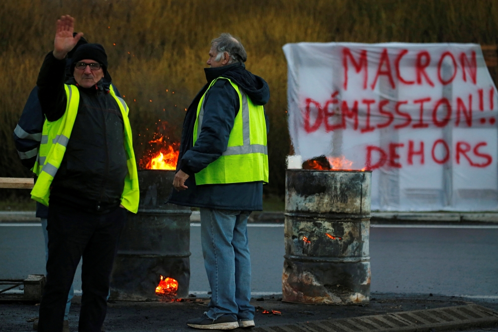 Protesters wearing yellow vests occupy a traffic island near the A2 Paris-Brussels motorway as part of the 