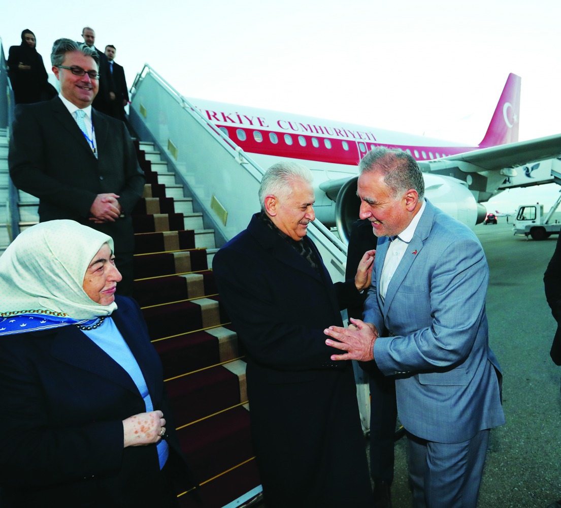 Turkish Parliament Speaker Binali Yildirim (2nd R) and his wife Semiha Yildirim (L) are welcomed upon their arrival at Tehran Mehrabad International Airport to attend a meeting of the parliament speakers of six countries (Iran, Russia, China, Pakistan, Tu