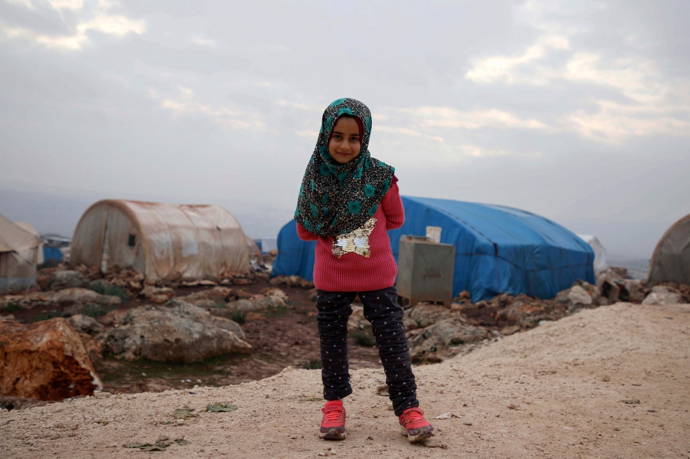 Syrian Maya Merhi poses for a picture in the Internally Displaced Persons (IDP) camp of Serjilla in northwestern Syria next to Bab al-Hawa border crossing with Turkey, on December 9, 2018.  / AFP / Aaref WATAD 