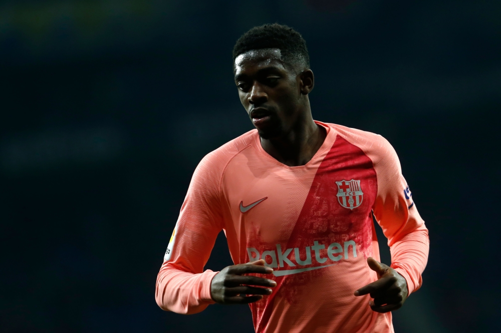 Barcelona's French forward Ousmane Dembele runs during the Spanish league football match RCD Espanyol against FC Barcelona at the RCDE Stadium in Cornella de Llobregat on December 8, 2018. / AFP / PAU BARRENA