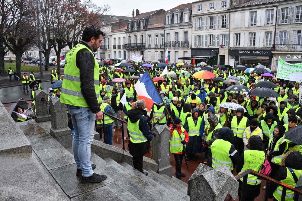 Protesters wearing Yellow Vests (Gilets jaunes) demonstrate against rising costs of living blamed on high taxes in Rochefort, south-western France on December 15, 2018, as part of a movement which has mushroomed into a widespread protest against stagnant 