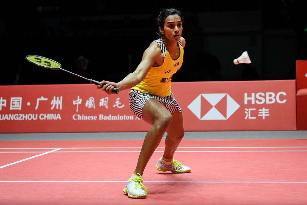 Sindhu Pusarla of India hits a return against Ratchanok Intanon of Thailand during their women's singles semi-final match at the 2018 BWF World Tour Finals badminton competition in Guangzhou in southern China's Guangdong province on December 15, 2018. Chi